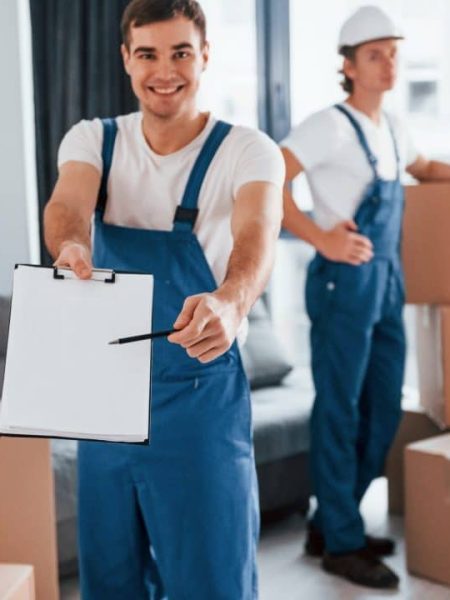 document-to-sign-two-young-movers-in-blue-uniform-working-indoors-in-the-room.jpg